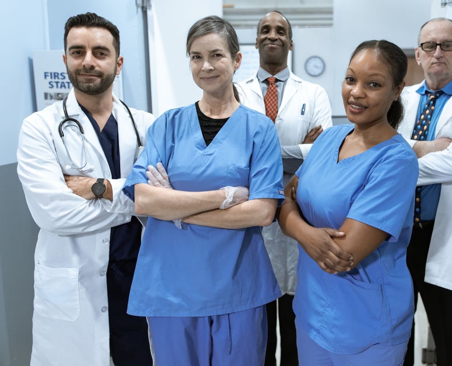 Doctors and nurses from a practice team standing together in a corridor