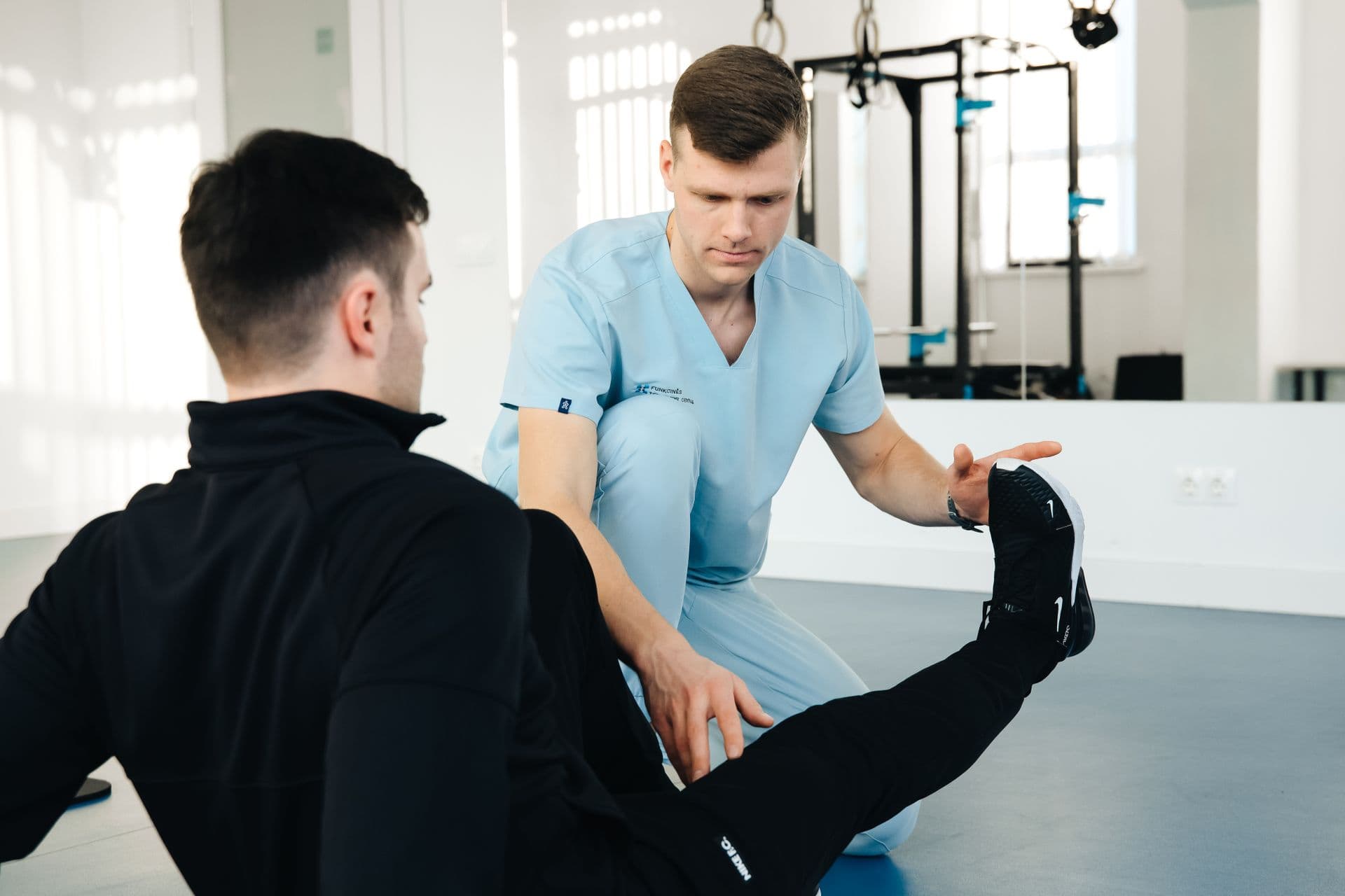 A physiotherapist assessing a patient's leg during a session